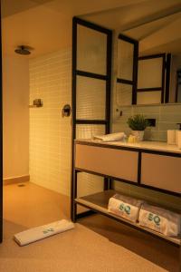 a bathroom with a sink and a mirror and towels at 5Q HOUSE Zona G in Bogotá +14 photos