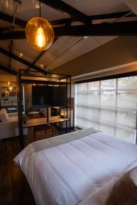 a bedroom with a large bed and a large window at 5Q HOUSE Zona G in Bogotá