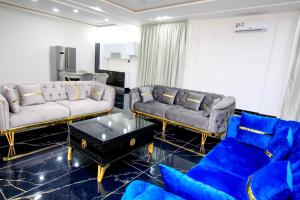 a living room with two couches and a table at America Guest House in Lomé