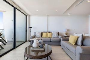 a living room with a couch and a table at Oceanfront Vibes Iconic Beachside Getaway in Puerto Peñasco +106 photos