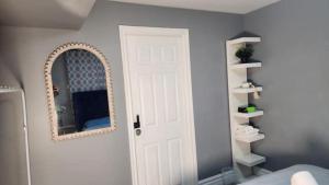 a room with a white door and a mirror at Private Greece inspired guest suite in Erindale in Mississauga