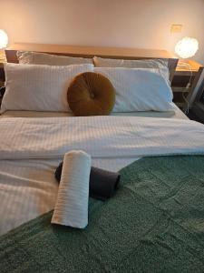 a bed with a pillow and a towel on it at Chic Town House in Melbourne