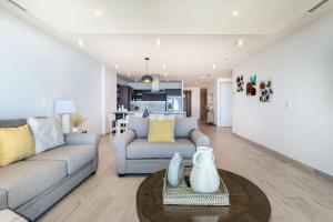a living room with a couch and a table at Oceanfront Vibes Iconic Beachside Getaway in Puerto Peñasco