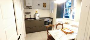 a small kitchen with a table and a bottle of wine at Mundaka Old town in Mundaka