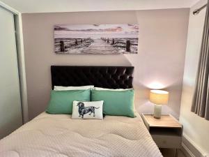 a bedroom with a bed with a painting on the wall at Bibis Home - Hertford in Hertford