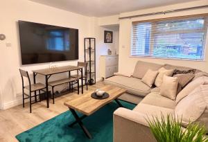 a living room with a couch and a table at Bibis Home - Hertford in Hertford