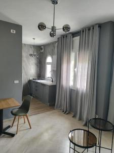 a room with a kitchen with a table and chairs at la Soukra in La Soukra