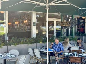 a group of people sitting at tables in a restaurant at Ocean Drive Oasis Beach Views South Beach Miami in Miami Beach