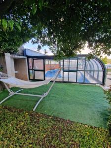 a hammock in a yard with a playground at Casa Cabanas piscina água quente de sal in Viana do Castelo
