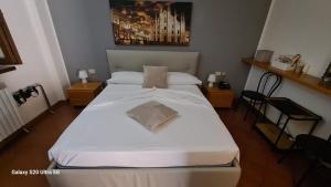 Un pat sau paturi într-o cameră la ALBERGO LA SCALETTA