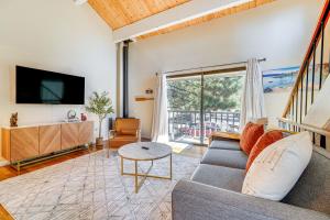 a living room with a couch and a tv at 5 Mi to Northstar Bear Den Home with Decks! in Kings Beach