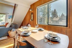 a dining room with a table and a large window at 5 Mi to Northstar Bear Den Home with Decks! in Kings Beach