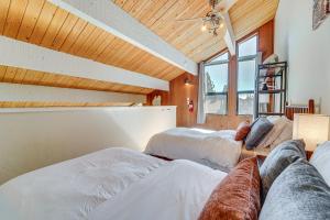 two beds in a room with a large window at 5 Mi to Northstar Bear Den Home with Decks! in Kings Beach +20 photos