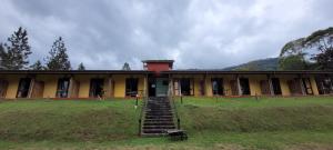 an old building with a staircase in a field at Pousada Ananda Parivara in Ubatuba