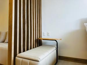 a room with a bed and a table and a stool at Exclusivo loft - frente al mar in Cartagena de Indias