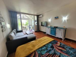a living room with a couch and a table at Grand studio les pieds dans l'eau! in Saint-François +20 photos