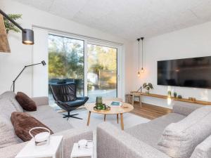a living room with a couch and a table at 5 star holiday home in Vestervig-By Traum in Vestervig