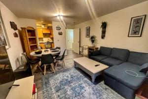 a living room with a couch and a table at 2 bed room , ensuite Flat close to Heathrow, Windsor , Langley in Langley Marish +21 photos