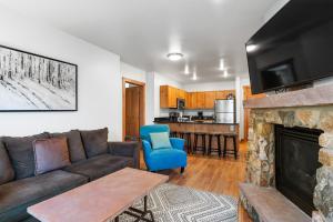 a living room with a couch and a fireplace at Expedition Station 8598 in Keystone