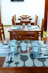 a table with cups and saucers on top at Antawa Hotel in Moquegua +32 photos