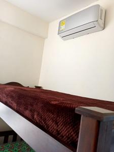 a room with a bed with a heater on the wall at Paraíso del sol in San Jerónimo