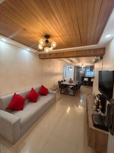 a living room with a couch and a dining room at CENTRICO 2Hab con Terraza y Picuzzi totalmente Privados in Santo Domingo +26 photos