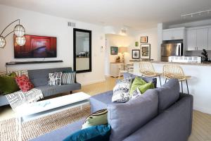 a living room with two couches and a kitchen at South Beach Walk to Sea Free Parking & Balcony Family & Pet Friendly in Miami Beach