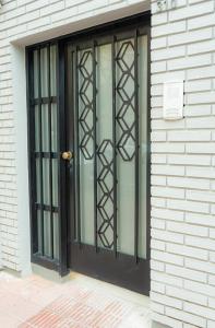 a black door on the side of a building at JC Apart in Córdoba +7 photos