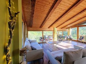 a living room with couches and chairs in a house at Masia La Clariana in Castelltallat