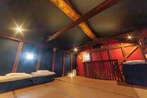 a room with two beds and a ceiling with lights at Tomareru Himitsukichi L-Base in Matsumoto +133 photos