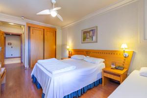 格拉玛多Suíte 453 Wish Serrano Resort Gramado的有两张床和一张桌子的酒店房间