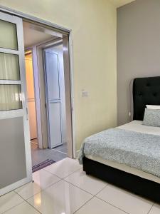 a bedroom with a bed and a sliding glass door at BS Homestay3 - 1 Bedroom Apartment in Miri Times Square in Miri