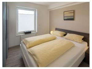 En eller flere senge i et værelse på Holiday apartment Zeppelinstek