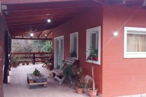 a red building with a patio with plants on it at Casa de campo en Yala, Jujuy in Yala
