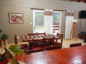 a dining room with tables and chairs and a window at Casa de campo en Yala, Jujuy in Yala