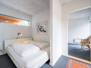 a bedroom with a bed and a mirror at 6 person holiday home in Henne in Henne Strand