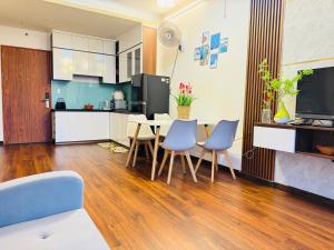 a kitchen and living room with a table and chairs at LeeThuyhomePR86 in Kinh Dinh +5 photos