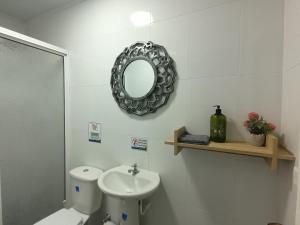a bathroom with a toilet and a mirror on the wall at Hospedaje Belleza Isleña habitaciones Individuales in San Andrés +27 photos