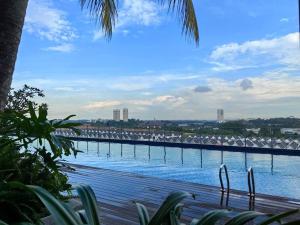 a large body of water with a bridge in the background at Midas Seri Alam 1BR, 1-4 pax in Masai