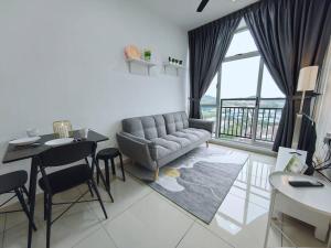 a living room with a couch and a table at Midas Seri Alam 1BR, 1-4 pax in Masai