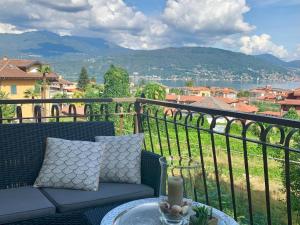 a balcony with a couch and a table with a view at Apartment in Baveno with Lake Maggiore Views in Baveno