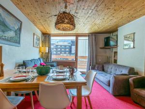 a living room with a table and a couch at Appartement cosy au centre de Val-d'Isère, proche des pistes - FR-1-694-276 in Val dʼIsère