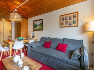 a living room with a gray couch and a table at Appartement cosy au centre de Val-d'Isère, proche des pistes - FR-1-694-276 in Val dʼIsère