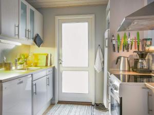 a kitchen with a white door and a sink and a stove at 5 person holiday home in Føllenslev-By Traum in Føllenslev