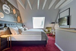 a bedroom with a large bed and a tv at Boutique by EMPA in Ulm +89 photos