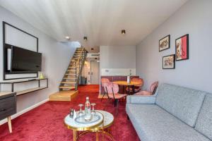 a living room with a couch and a table at Boutique by EMPA in Ulm