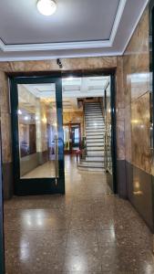 a hallway of a building with a door and stairs at Micro-centro BA in Buenos Aires