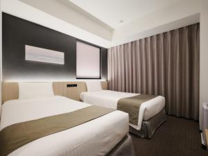 Postel nebo postele na pokoji v ubytování hotel MONday Premium TOYOSU