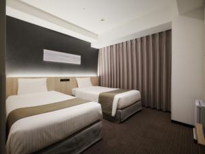 Postel nebo postele na pokoji v ubytování hotel MONday Premium TOYOSU