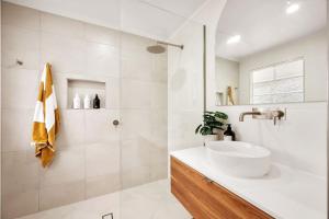 a white bathroom with a sink and a shower at 3 Palms Lagoon Pool Villa in North Ward +15 photos